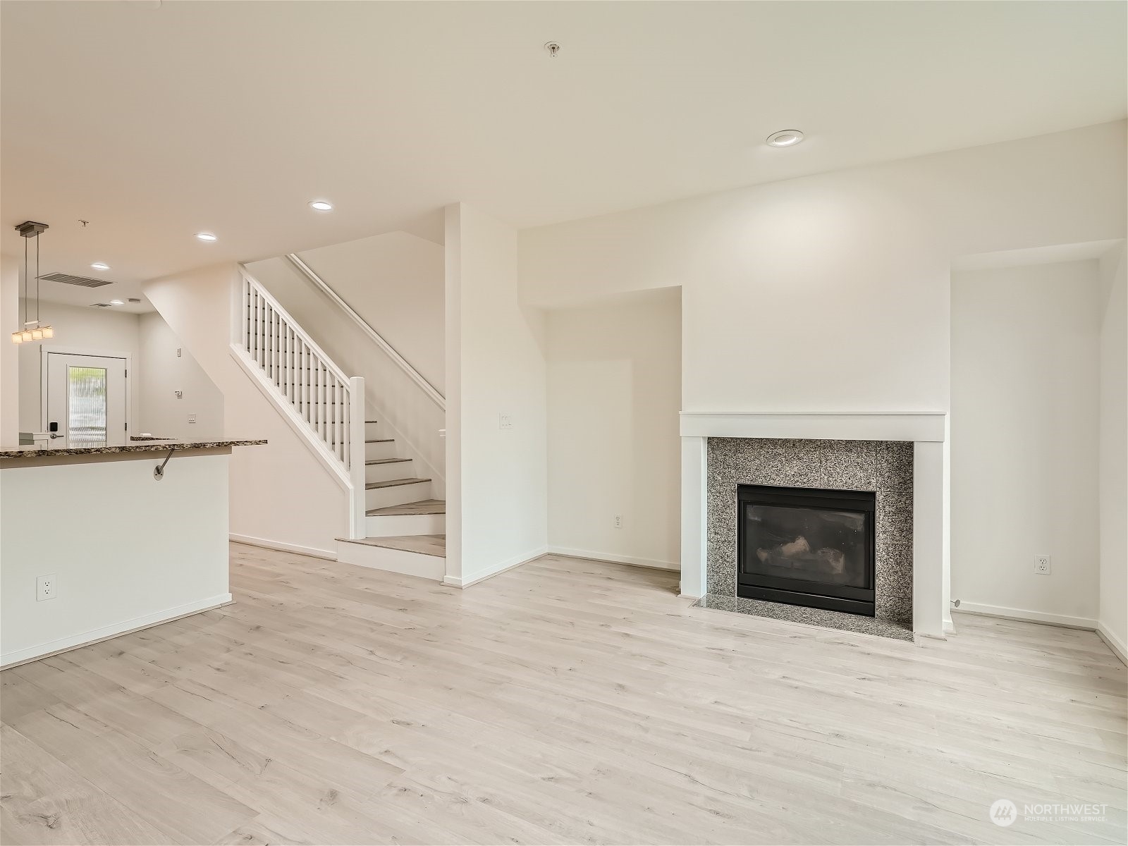 101 Sky Ridge Road Northwest, Unit 502 Issaquah, WA 98027 - Photo 16 of 31 an entryway and an empty room with wooden floor