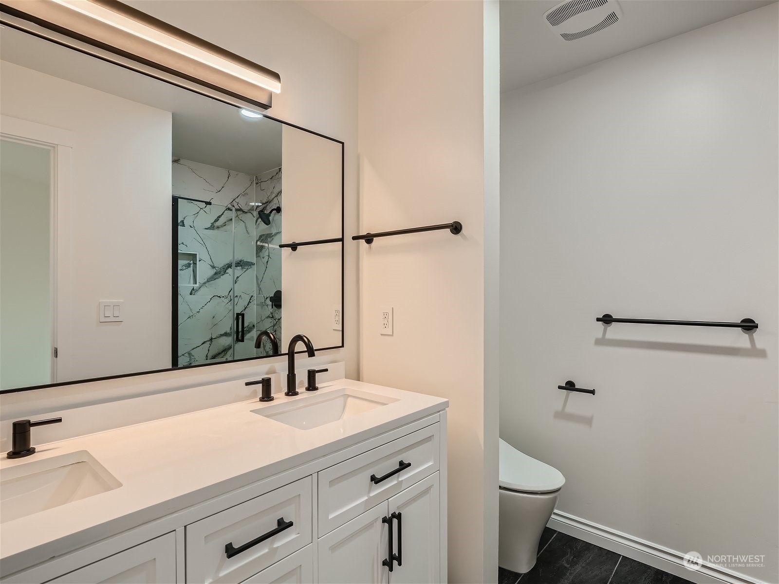 101 Sky Ridge Road Northwest, Unit 502 Issaquah, WA 98027 - Photo 24 of 31 a bathroom with a sink and a mirror