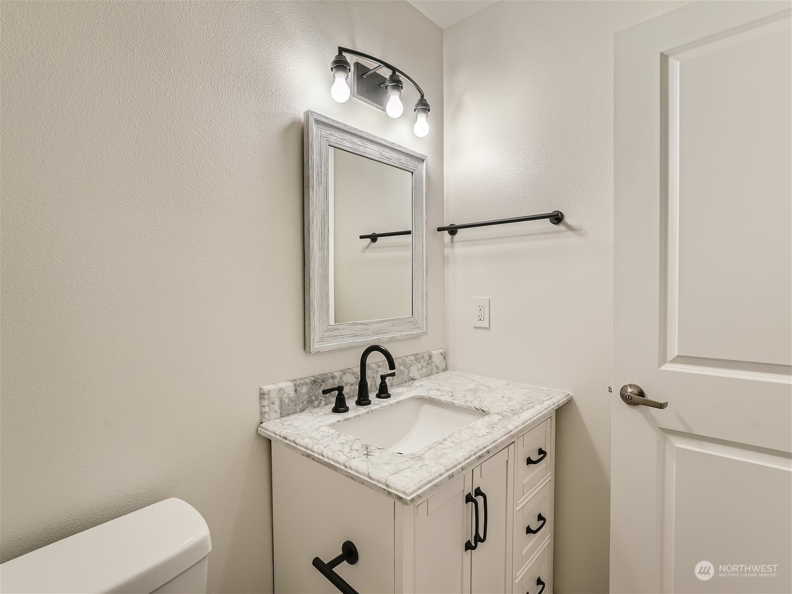 101 Sky Ridge Road Northwest, Unit 502 Issaquah, WA 98027 - Photo 29 of 31 a bathroom with a granite countertop sink toilet and mirror