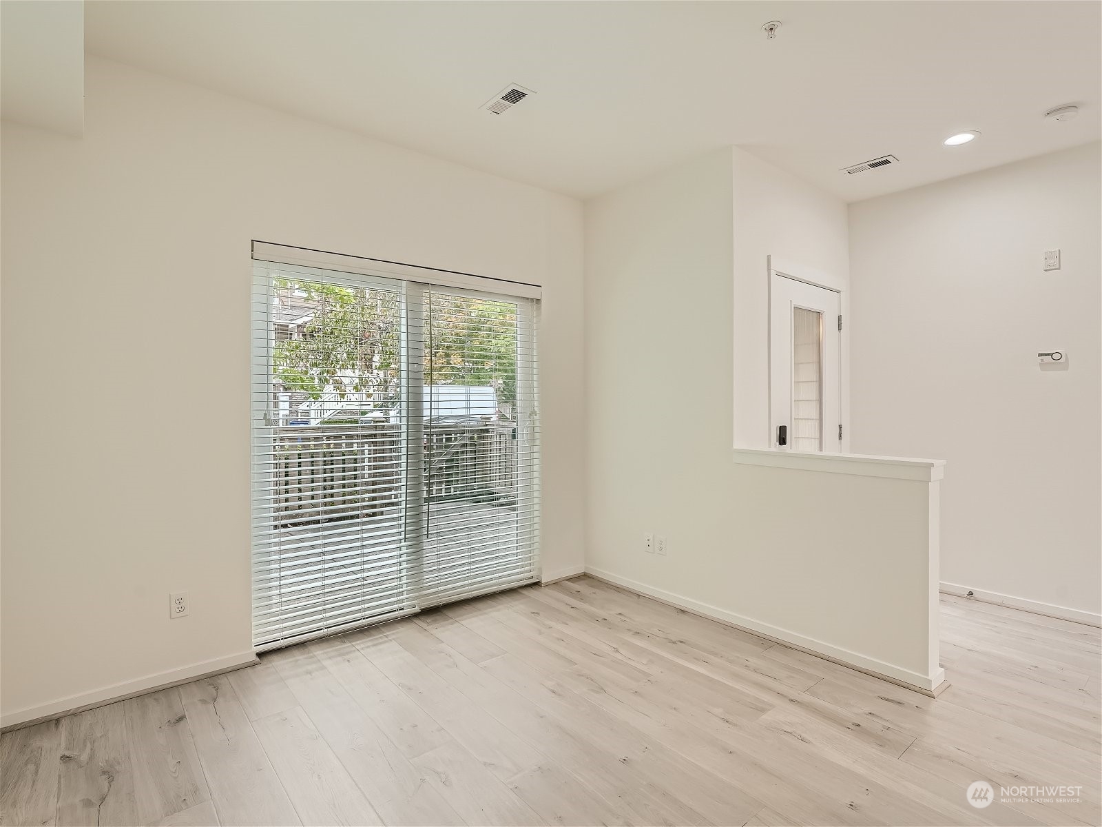 101 Sky Ridge Road Northwest, Unit 502 Issaquah, WA 98027 - Photo 7 of 31 an empty room with wooden floor and windows