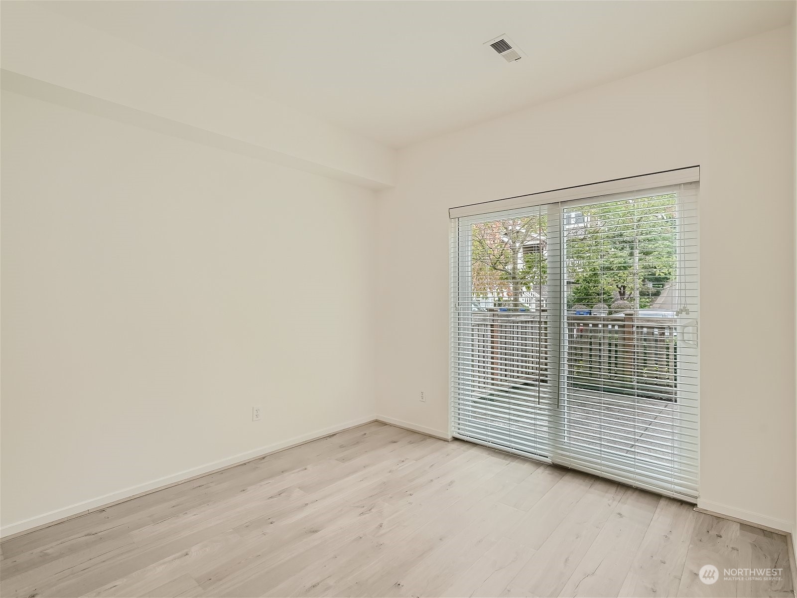 101 Sky Ridge Road Northwest, Unit 502 Issaquah, WA 98027 - Photo 9 of 31 a view of an empty room with wooden floor and a window