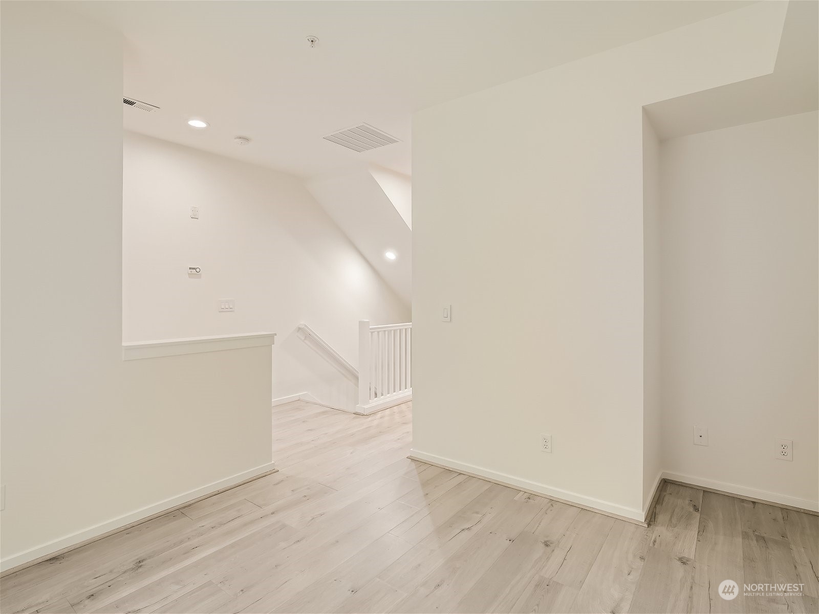 101 Sky Ridge Road Northwest, Unit 502 Issaquah, WA 98027 - Photo 10 of 31 an empty room with wooden floor
