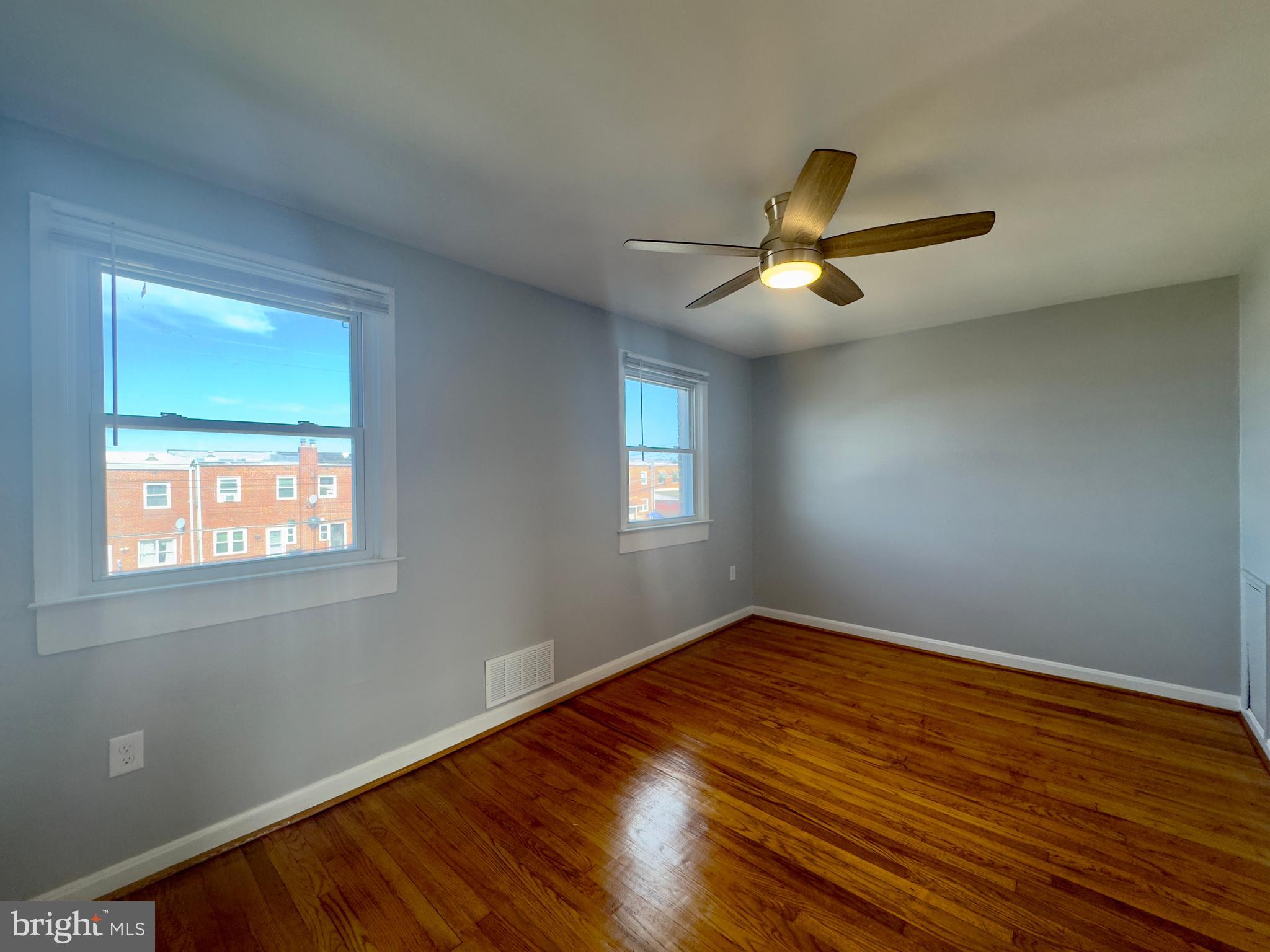 7716 Wynbrook Road Baltimore, MD 21224 - Photo 15 of 15 a view of empty room with wooden floor and fan