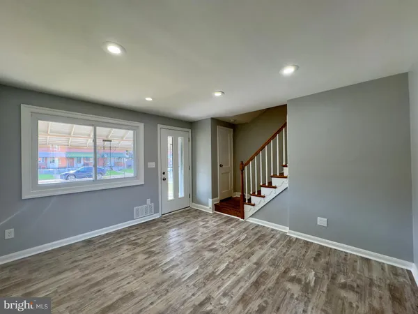 a view of an entryway with wooden floor