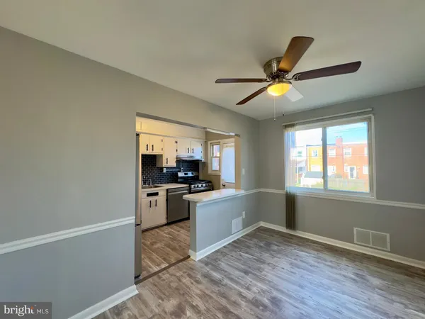 a kitchen with a refrigerator and a stove top oven