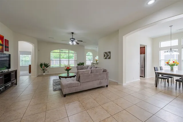 a living room with furniture a fireplace and a window