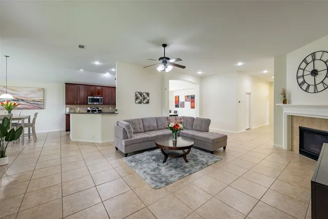 a living room with furniture a flat screen tv and a fireplace