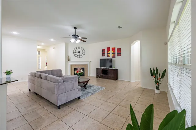 a view of a dining room with furniture a chandelier and wooden floor