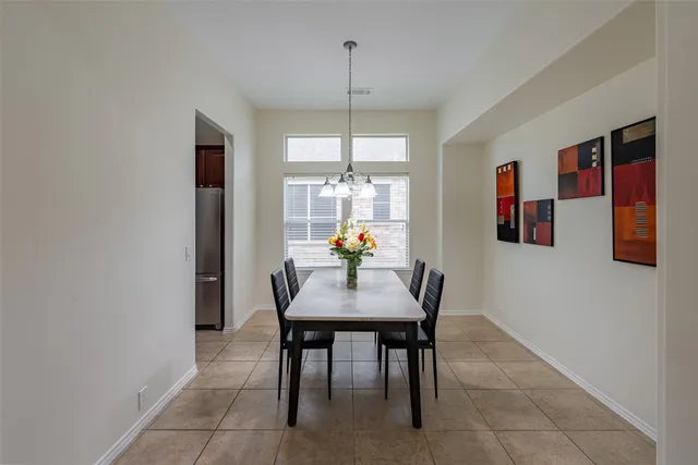 a dining room with kitchen island furniture a chandelier and kitchen view