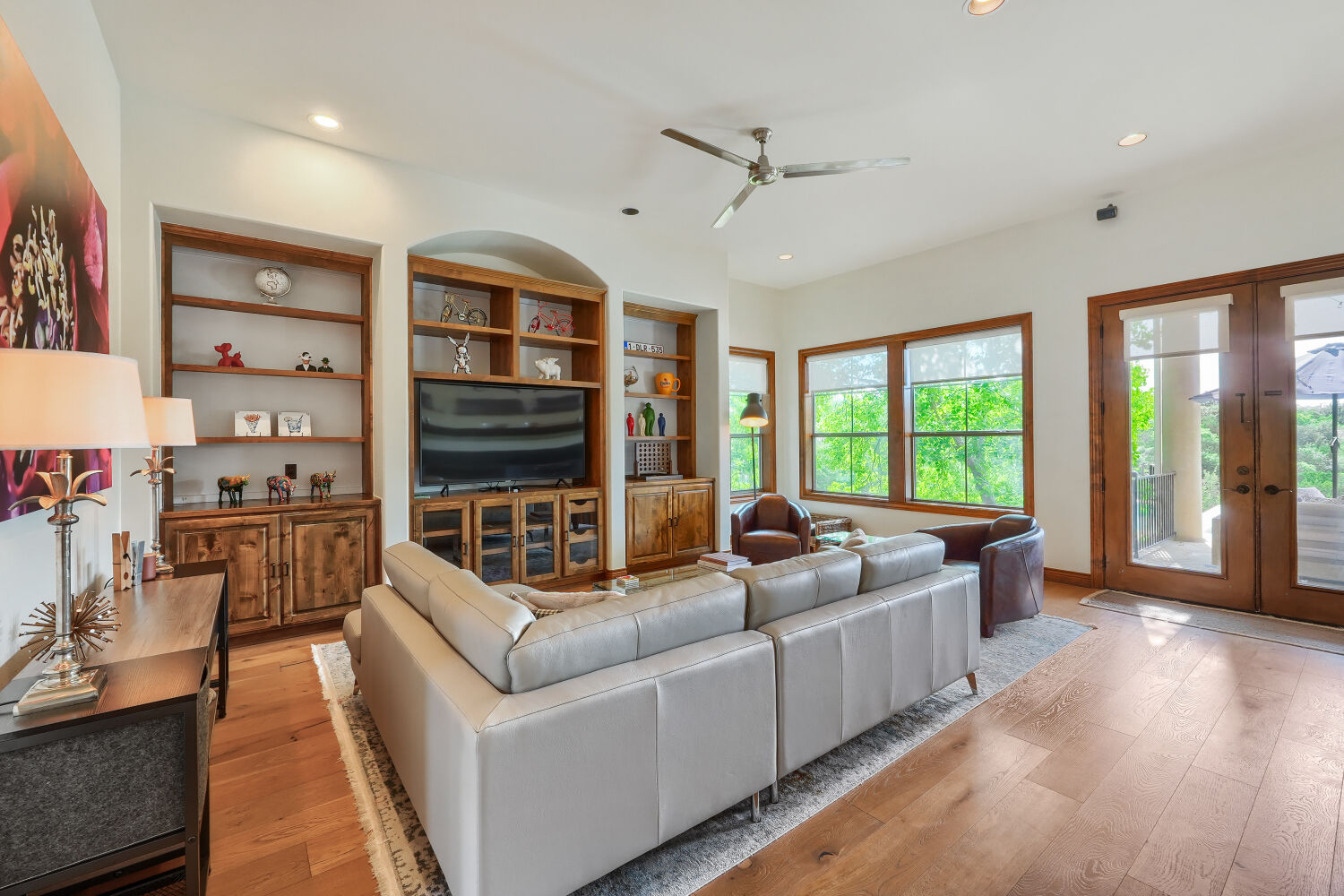 701 Hurst Creek Road Lakeway, TX 78734 - Photo 8 of 37 Spacious living room with lots of natural lighting, open to the kitchen area. Updated flooring throughout. High ceilings with built-in shelves.