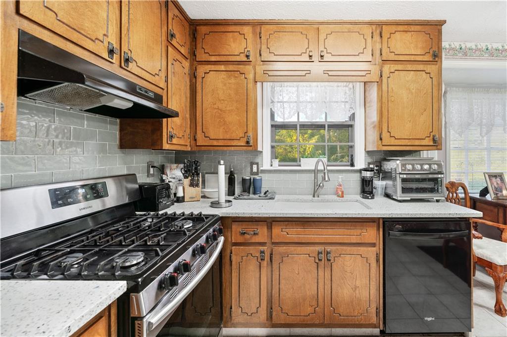 6633 Cameron Road Morrow, GA 30260 - Photo 11 of 41 a kitchen with a stove a sink and a cabinets