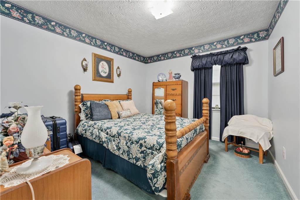 6633 Cameron Road Morrow, GA 30260 - Photo 13 of 41 a bed room with a bed and a chair