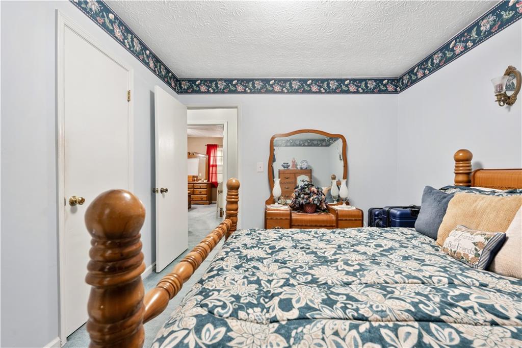 6633 Cameron Road Morrow, GA 30260 - Photo 14 of 41 a bedroom with furniture and a mirror