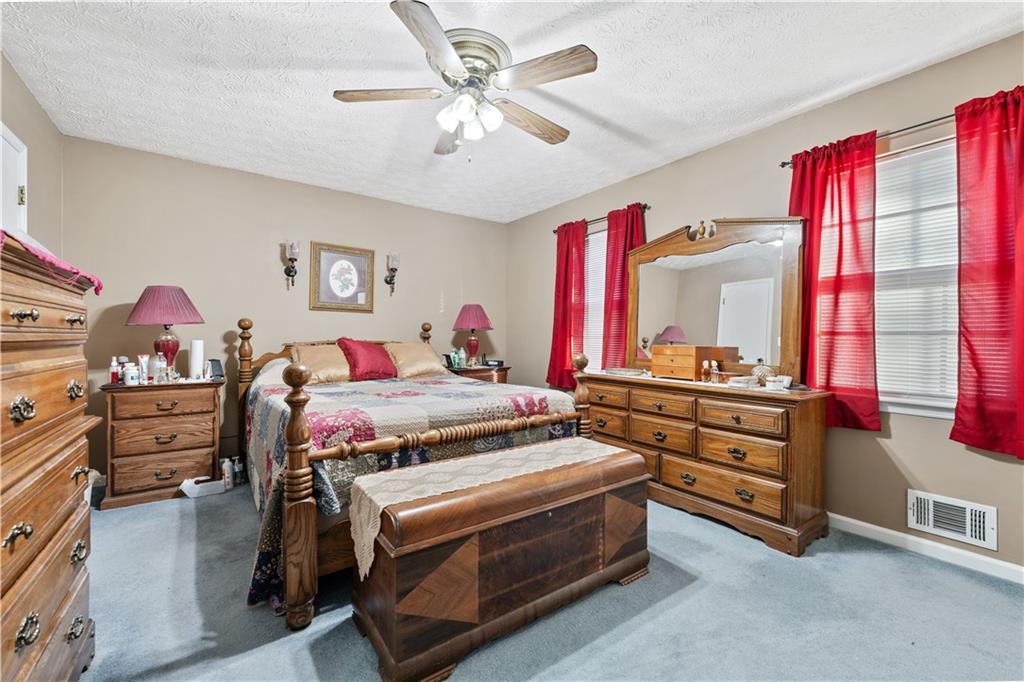 6633 Cameron Road Morrow, GA 30260 - Photo 16 of 41 a bedroom with a bed and a dresser