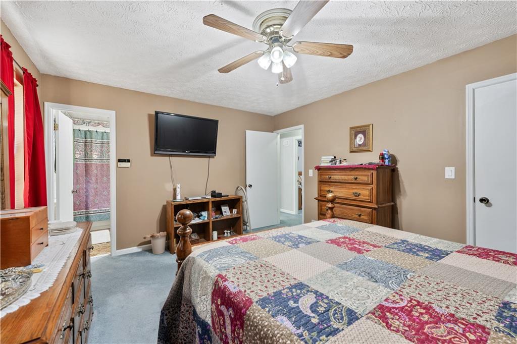 6633 Cameron Road Morrow, GA 30260 - Photo 17 of 41 a bedroom with a bed and a flat screen tv