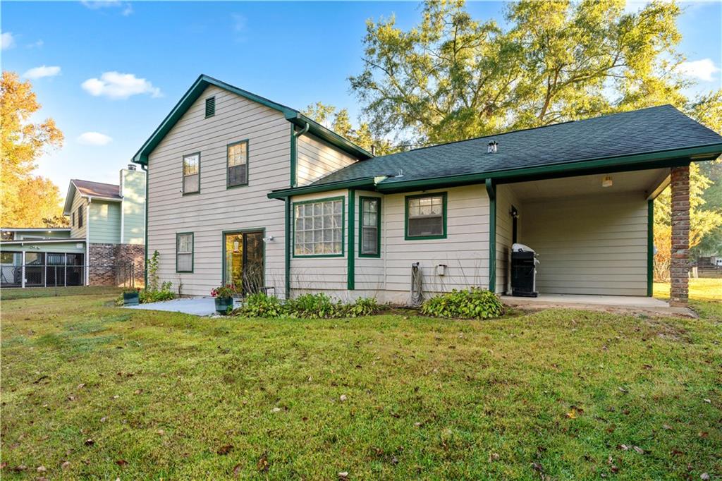 6633 Cameron Road Morrow, GA 30260 - Photo 31 of 41 a front view of house with yard and trees in the background
