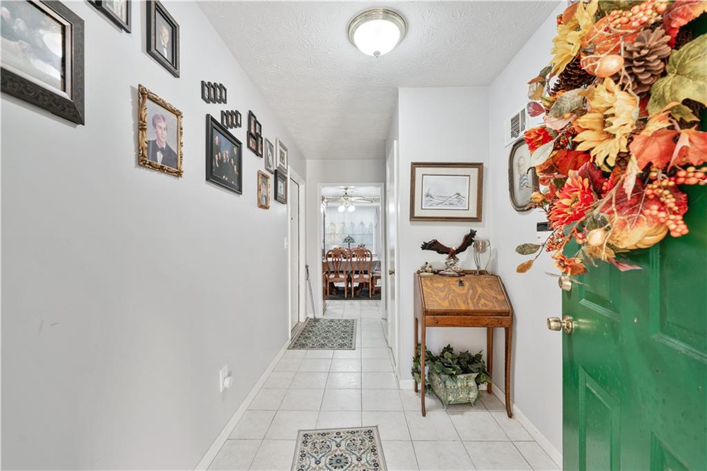 6633 Cameron Road Morrow, GA 30260 - Photo 35 of 41 a hallway with beautiful frames and flower vase