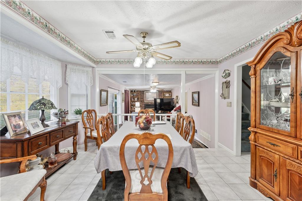 6633 Cameron Road Morrow, GA 30260 - Photo 7 of 41 a living room with furniture a chandelier and a large window