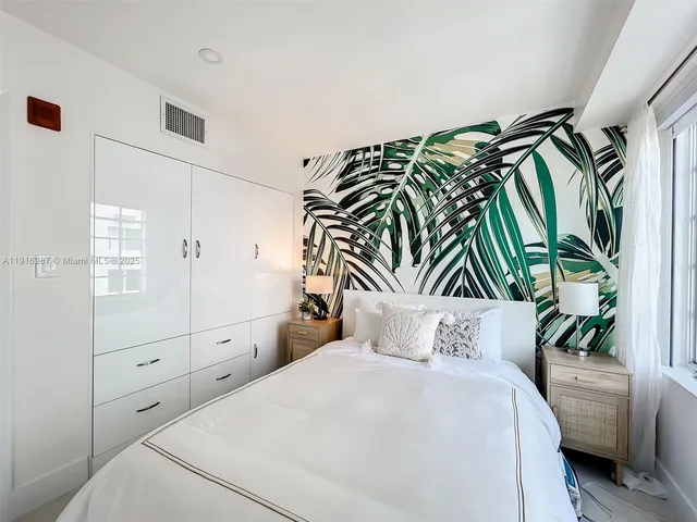 a bedroom with a bed and a potted plant