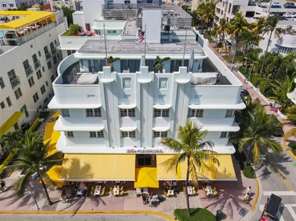 a view of residential houses with swimming pool and large trees