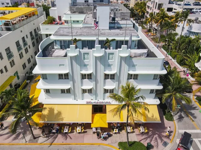 a view of residential houses with swimming pool and large trees