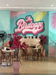 an outdoor dining space with furniture and umbrella