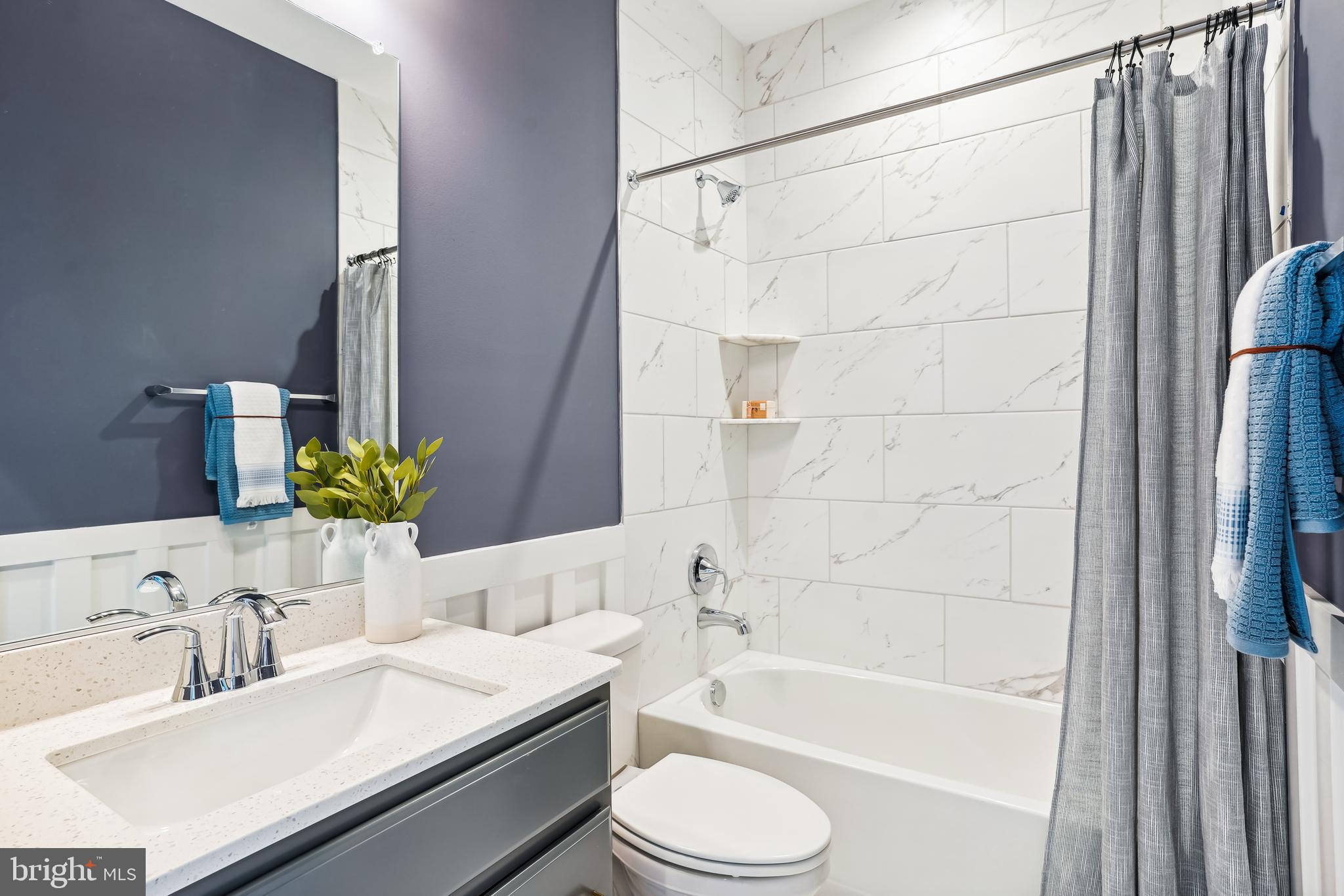 4996 Ilchester Road Ellicott City, MD 21043 - Photo 37 of 74 a bathroom with a granite countertop bathtub sink vanity mirror and toilet
