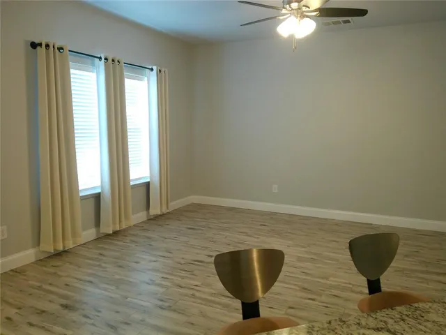 a view of a room with gym equipment and a chandelier