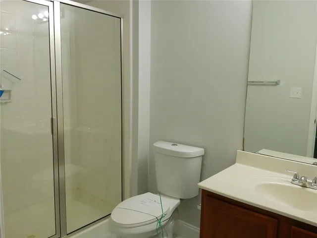 a white toilet sitting next to a bathroom sink