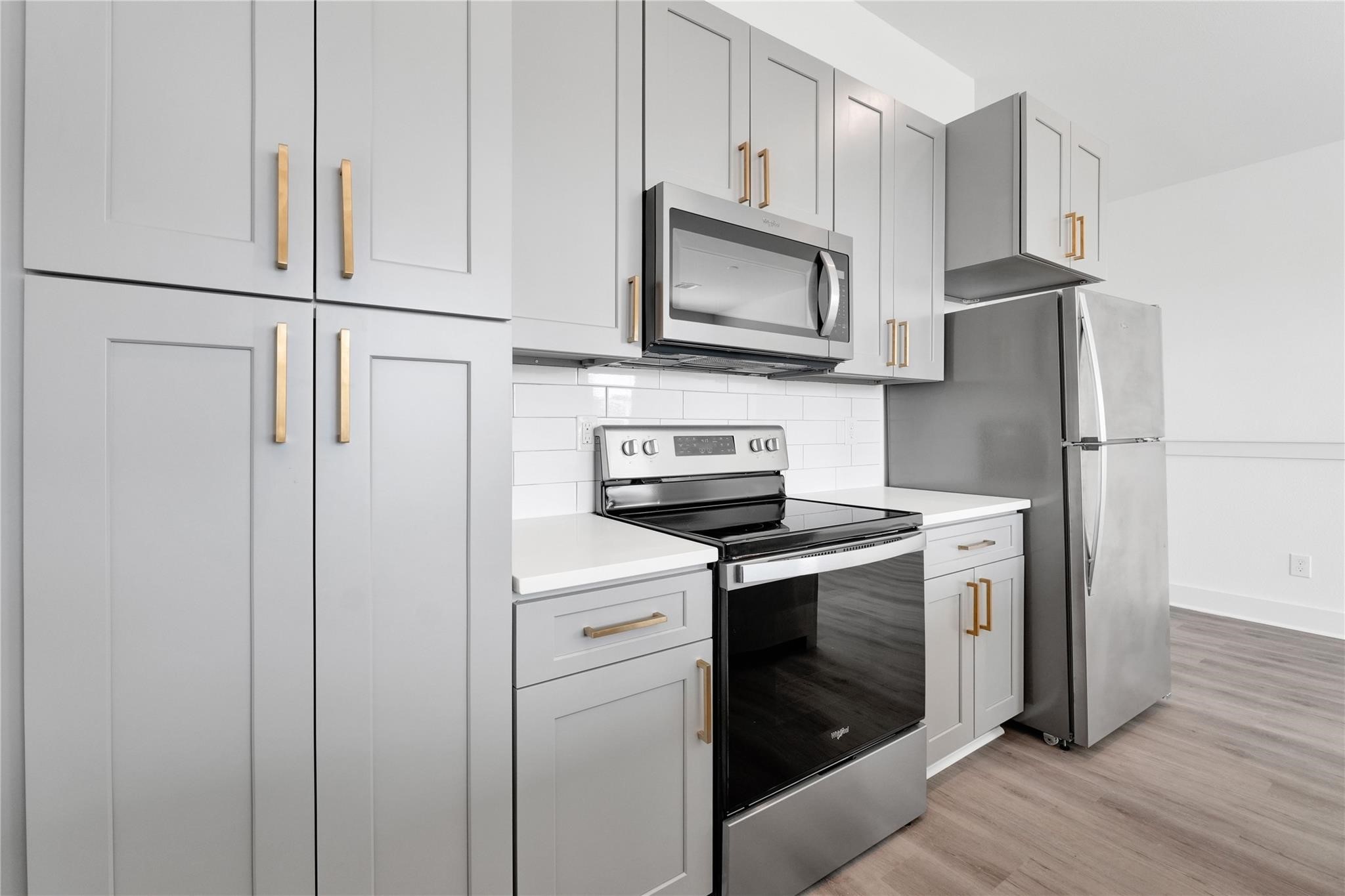 3210 Frying Pan Place, Unit A Katy, TX 77449 - Photo 11 of 39 a kitchen with white cabinets and stainless steel appliances