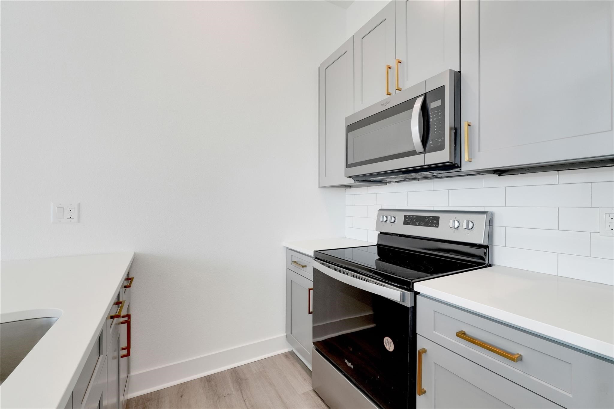 3210 Frying Pan Place, Unit A Katy, TX 77449 - Photo 13 of 39 a kitchen with microwave cabinets and stove top oven