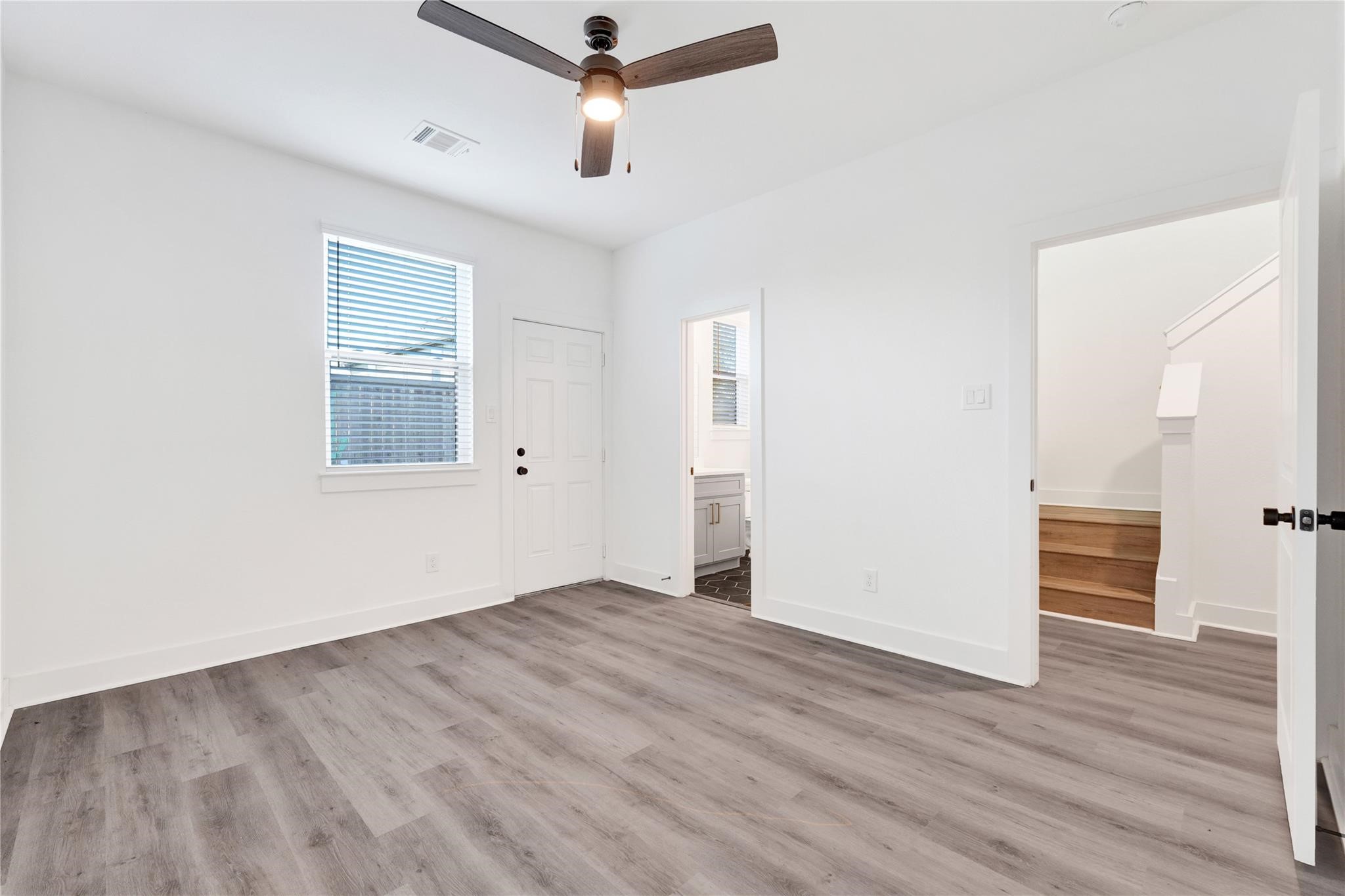 3210 Frying Pan Place, Unit A Katy, TX 77449 - Photo 24 of 39 an empty room with wooden floor cabinet and windows