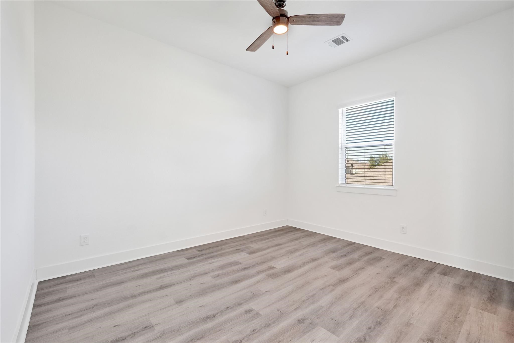 3210 Frying Pan Place, Unit A Katy, TX 77449 - Photo 29 of 39 an empty room with a window and a ceiling fan