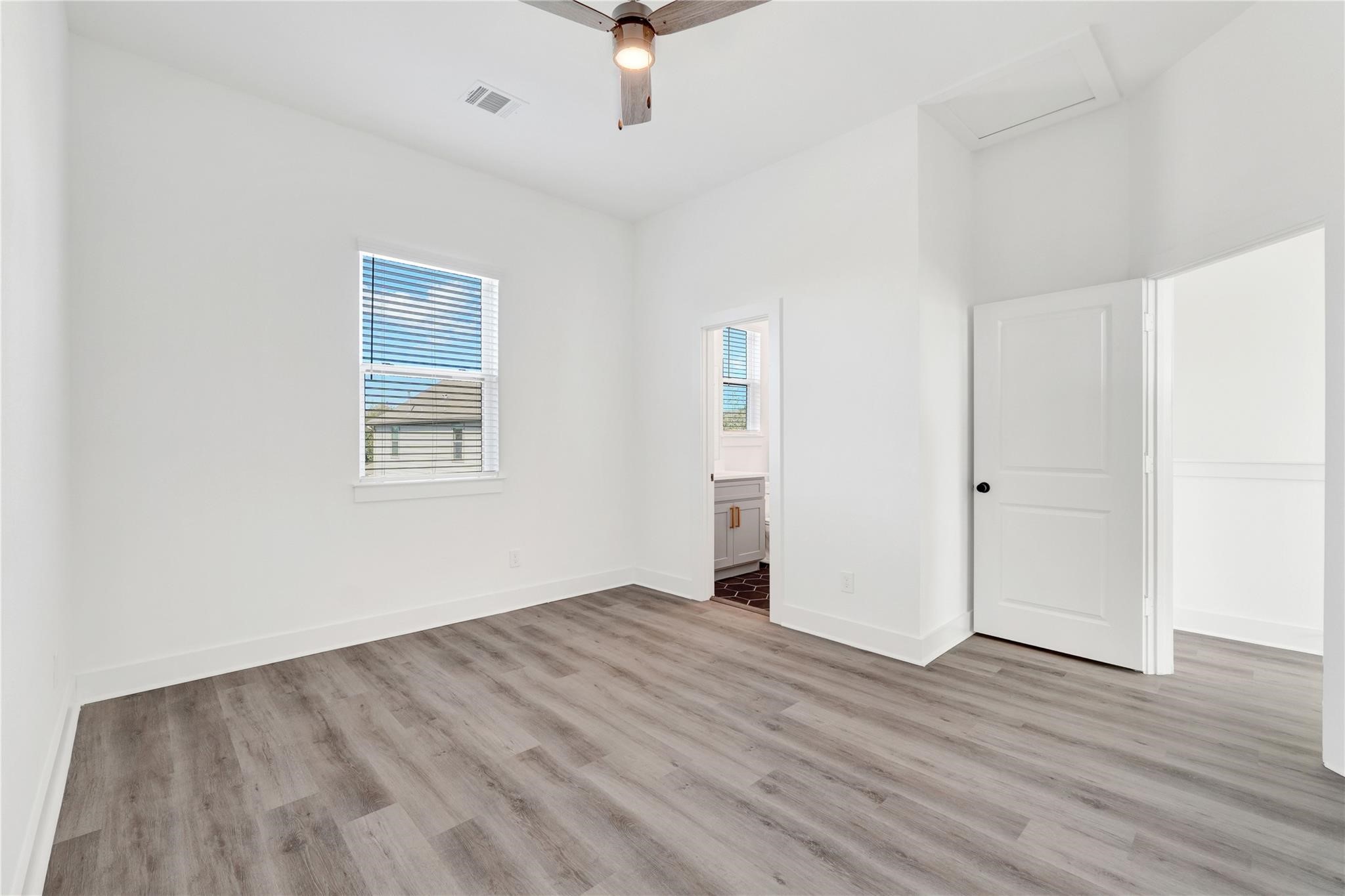 3210 Frying Pan Place, Unit A Katy, TX 77449 - Photo 31 of 39 wooden floor in an empty room with a window