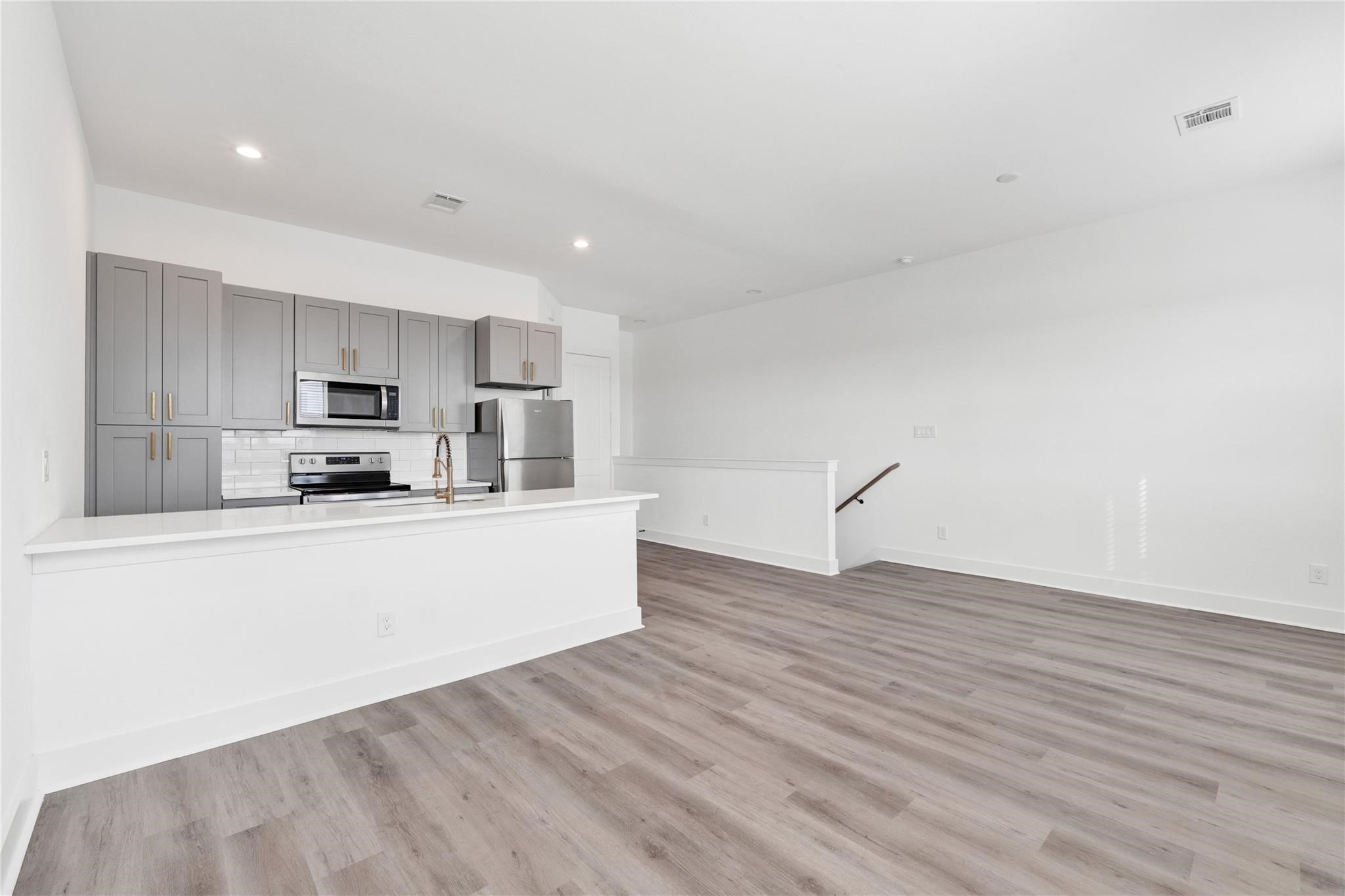 3210 Frying Pan Place, Unit A Katy, TX 77449 - Photo 10 of 39 a kitchen with stainless steel appliances granite countertop a stove a sink and a refrigerator