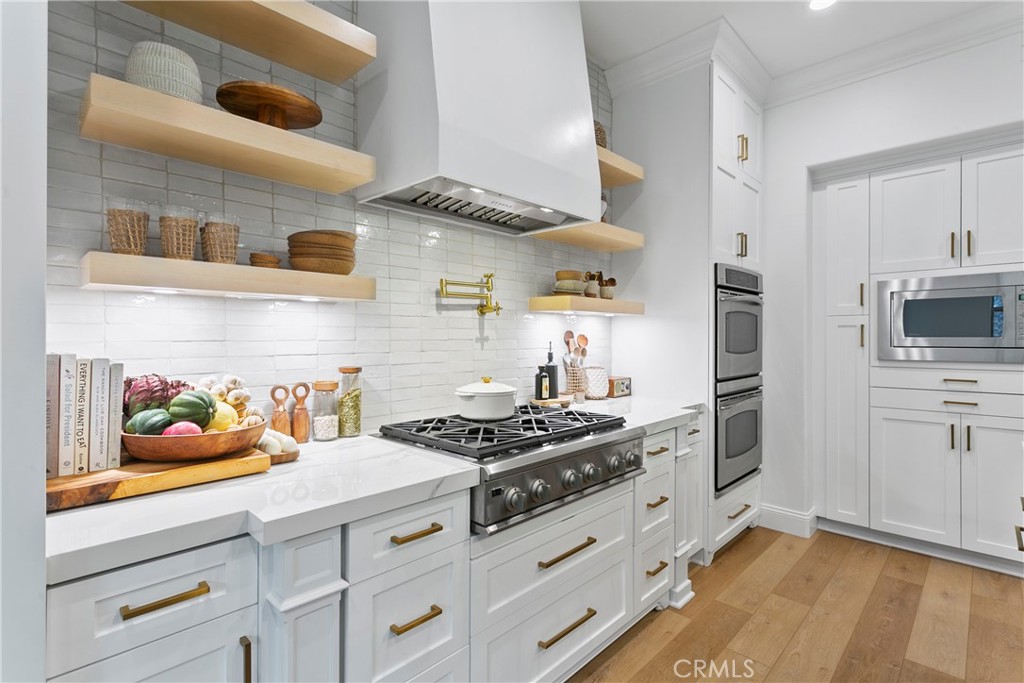 3 Adele Street Ladera Ranch, CA 92694 - Photo 15 of 34 a kitchen with stainless steel appliances a stove and a microwave