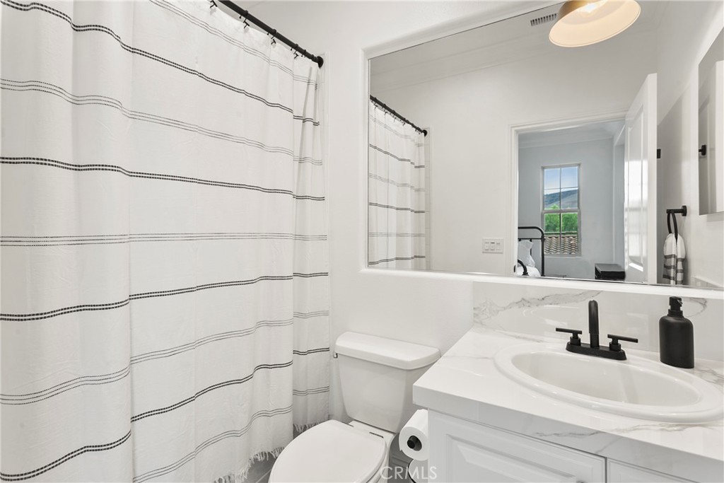 3 Adele Street Ladera Ranch, CA 92694 - Photo 25 of 34 a bathroom with a sink toilet and shower