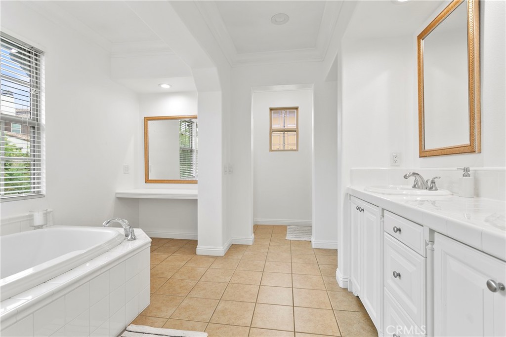 3 Adele Street Ladera Ranch, CA 92694 - Photo 28 of 34 a spacious bathroom with a tub sink and mirror