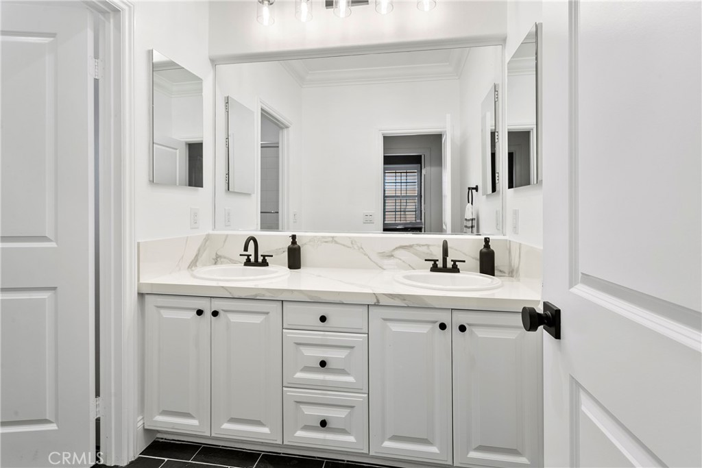 3 Adele Street Ladera Ranch, CA 92694 - Photo 33 of 34 a bathroom with a sink and a mirror