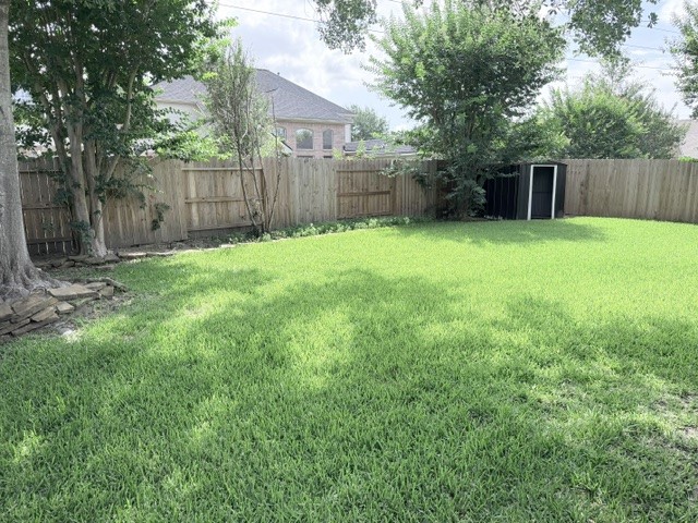 20030 Castlegreen Drive Spring, TX 77388 - Photo 23 of 23 a view of a backyard with a small cabin and wooden fence