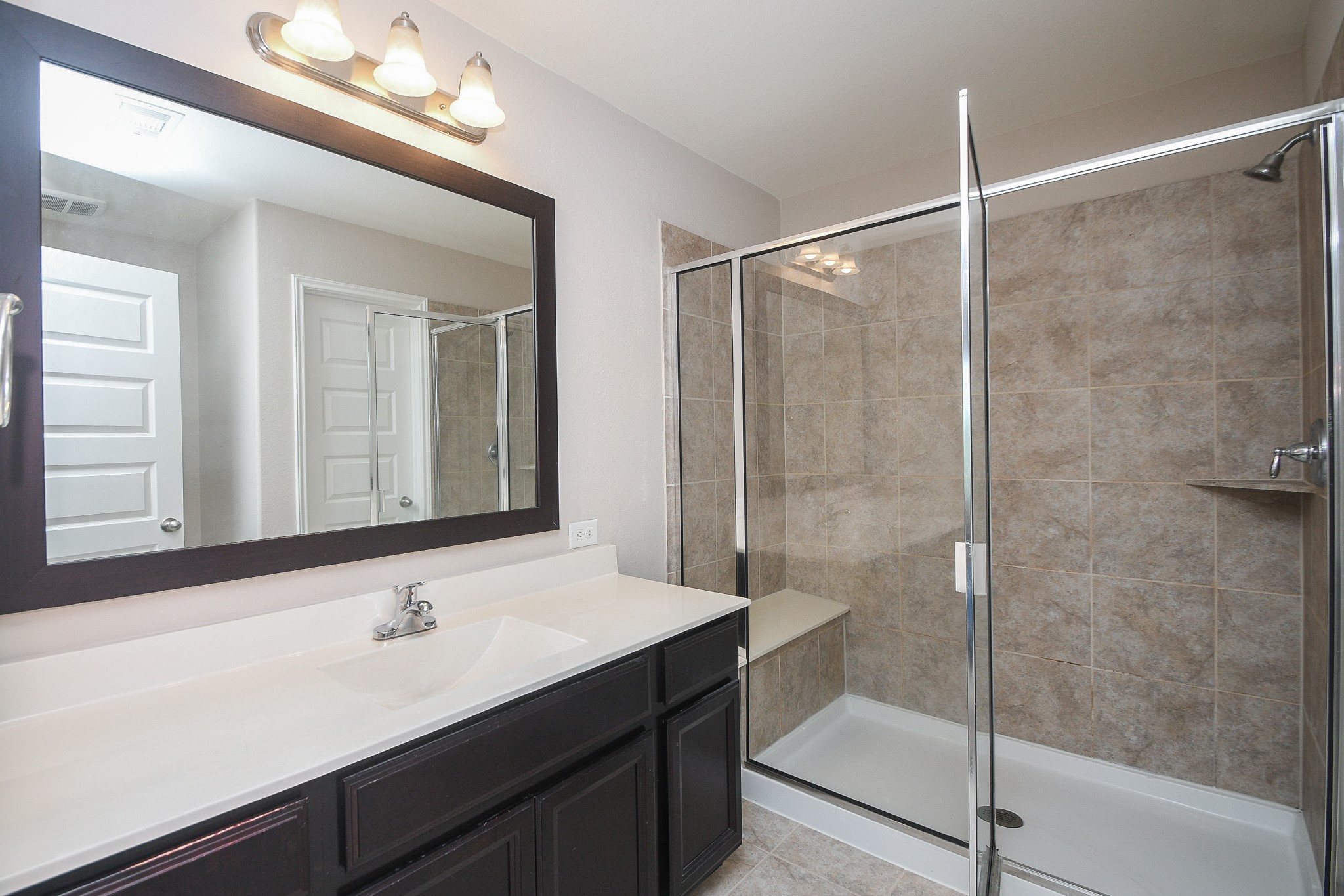 22139 Rustling Springs Drive Spring, TX 77389 - Photo 14 of 23 a bathroom with a shower sink and mirror