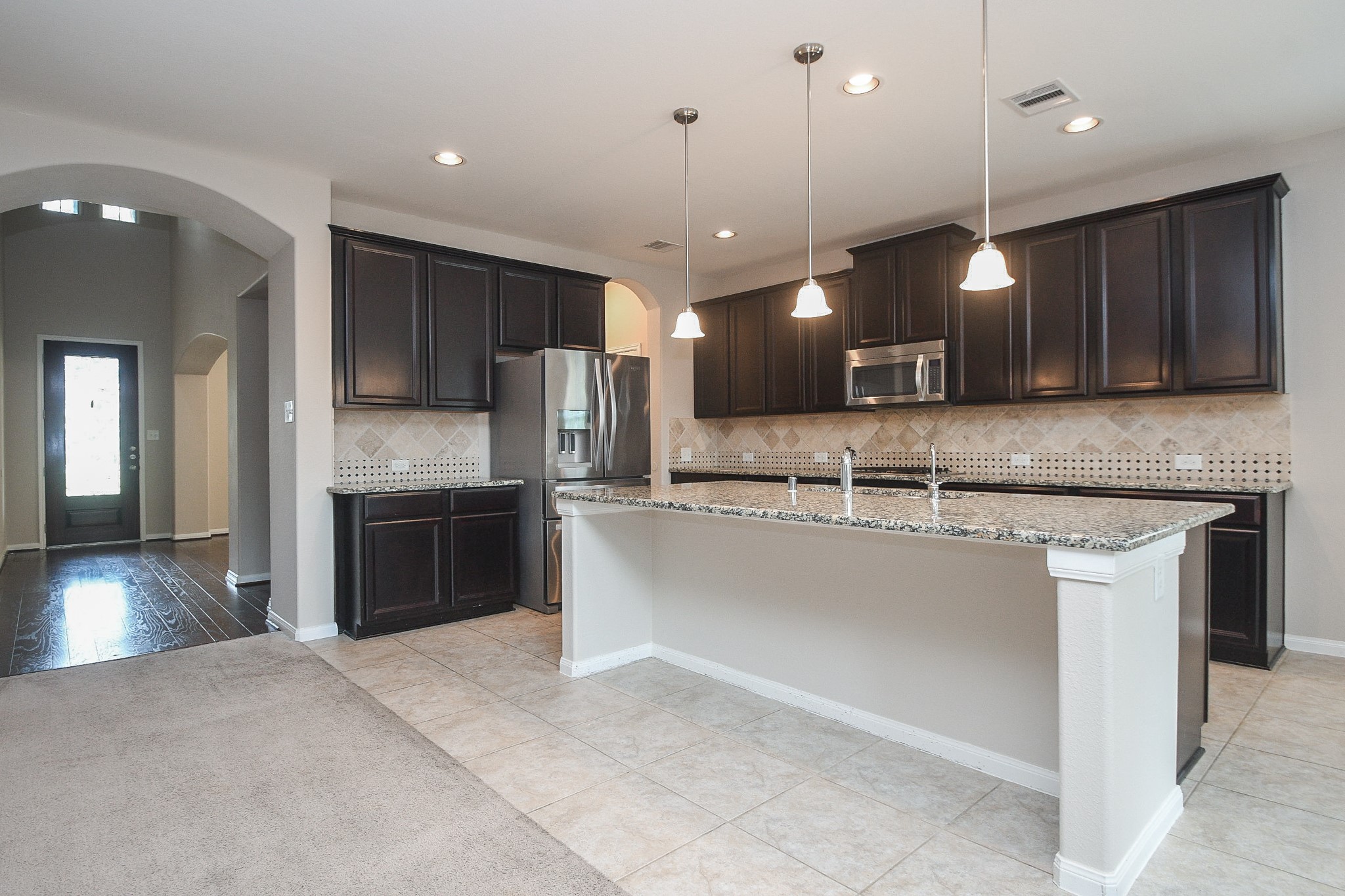 22139 Rustling Springs Drive Spring, TX 77389 - Photo 3 of 23 a kitchen with kitchen island a counter top space appliances and cabinets