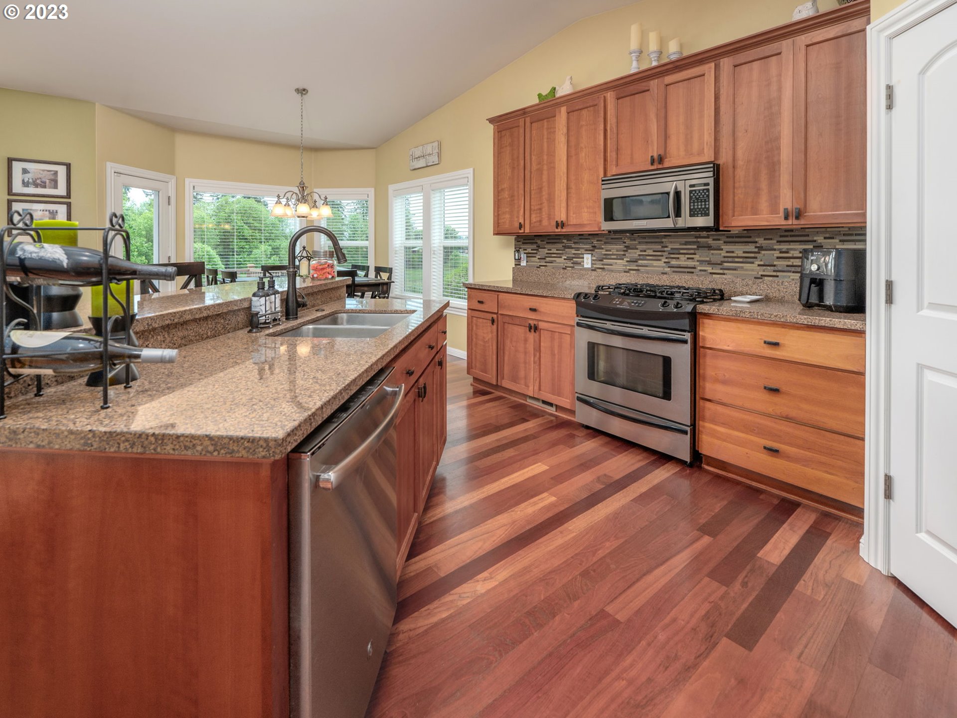 56470 Hazen Road Warren, OR 97053 - Photo 11 of 39 a kitchen with stainless steel appliances granite countertop a stove a sink and a microwave