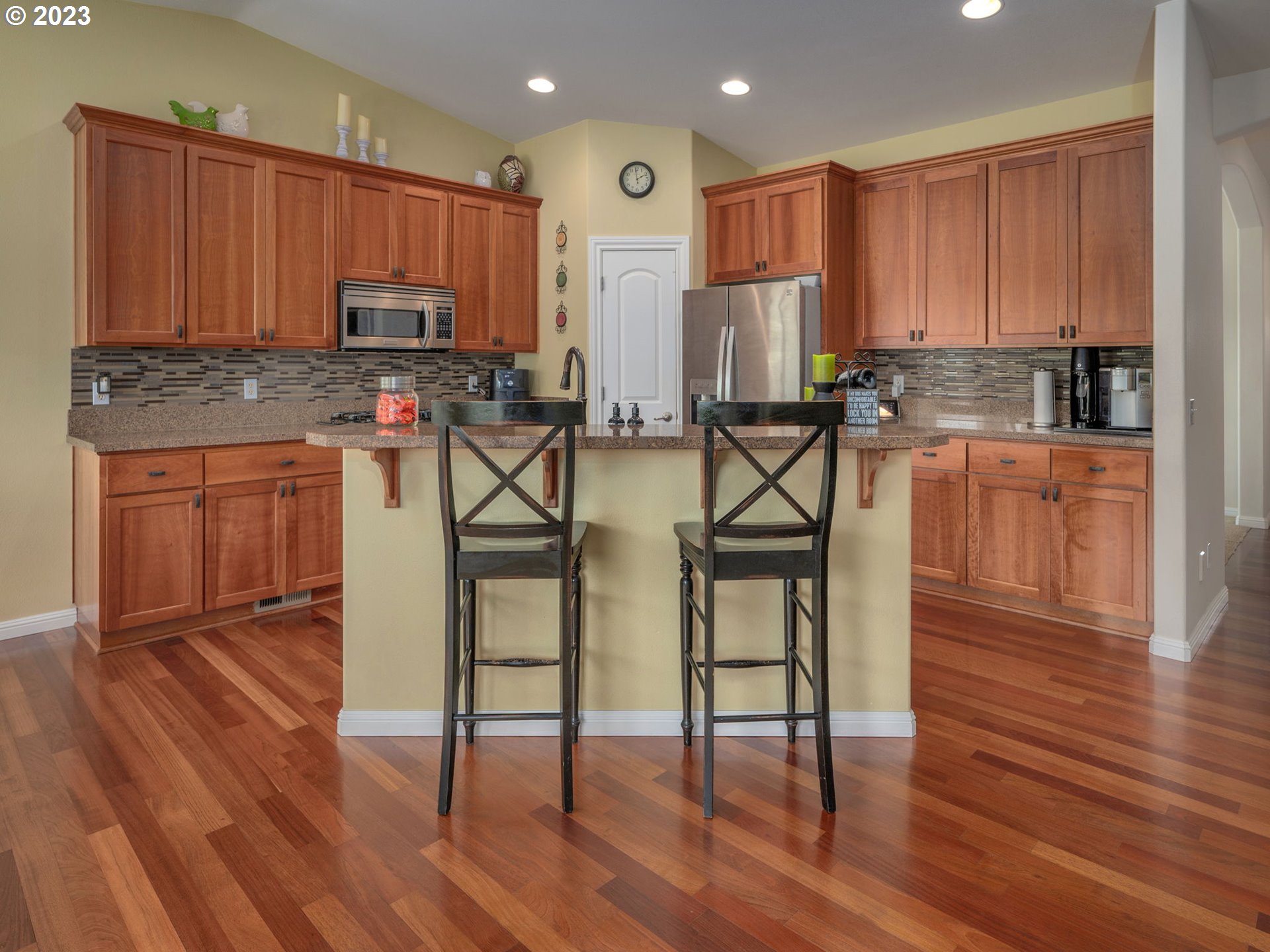 56470 Hazen Road Warren, OR 97053 - Photo 12 of 39 a kitchen with stainless steel appliances granite countertop wooden cabinets a stove a sink and dishwasher with wooden floor