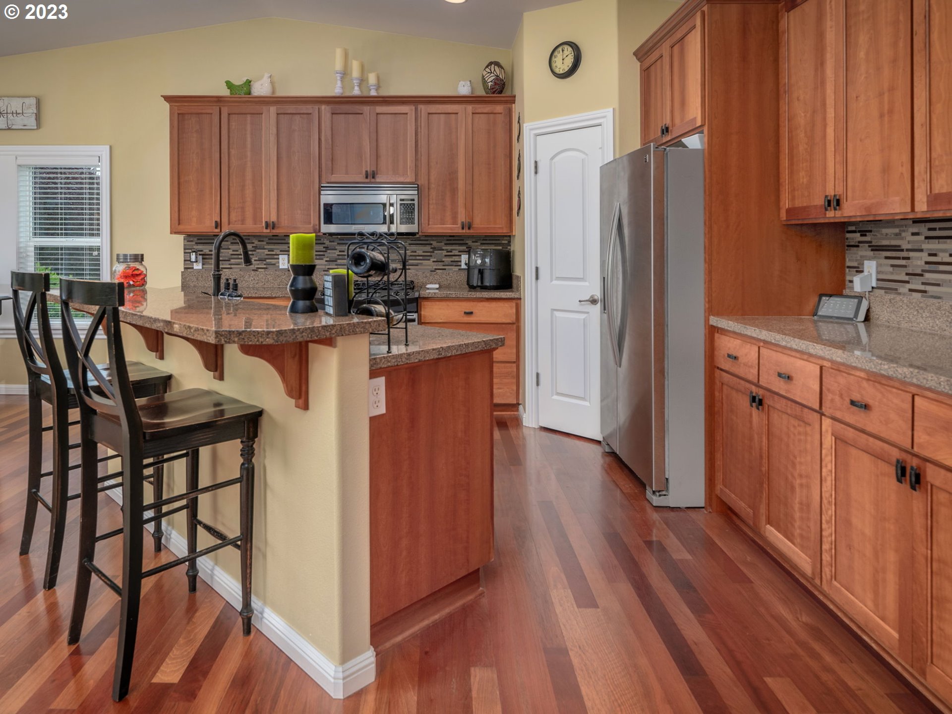 56470 Hazen Road Warren, OR 97053 - Photo 13 of 39 a kitchen with granite countertop wooden floors cabinets and appliances