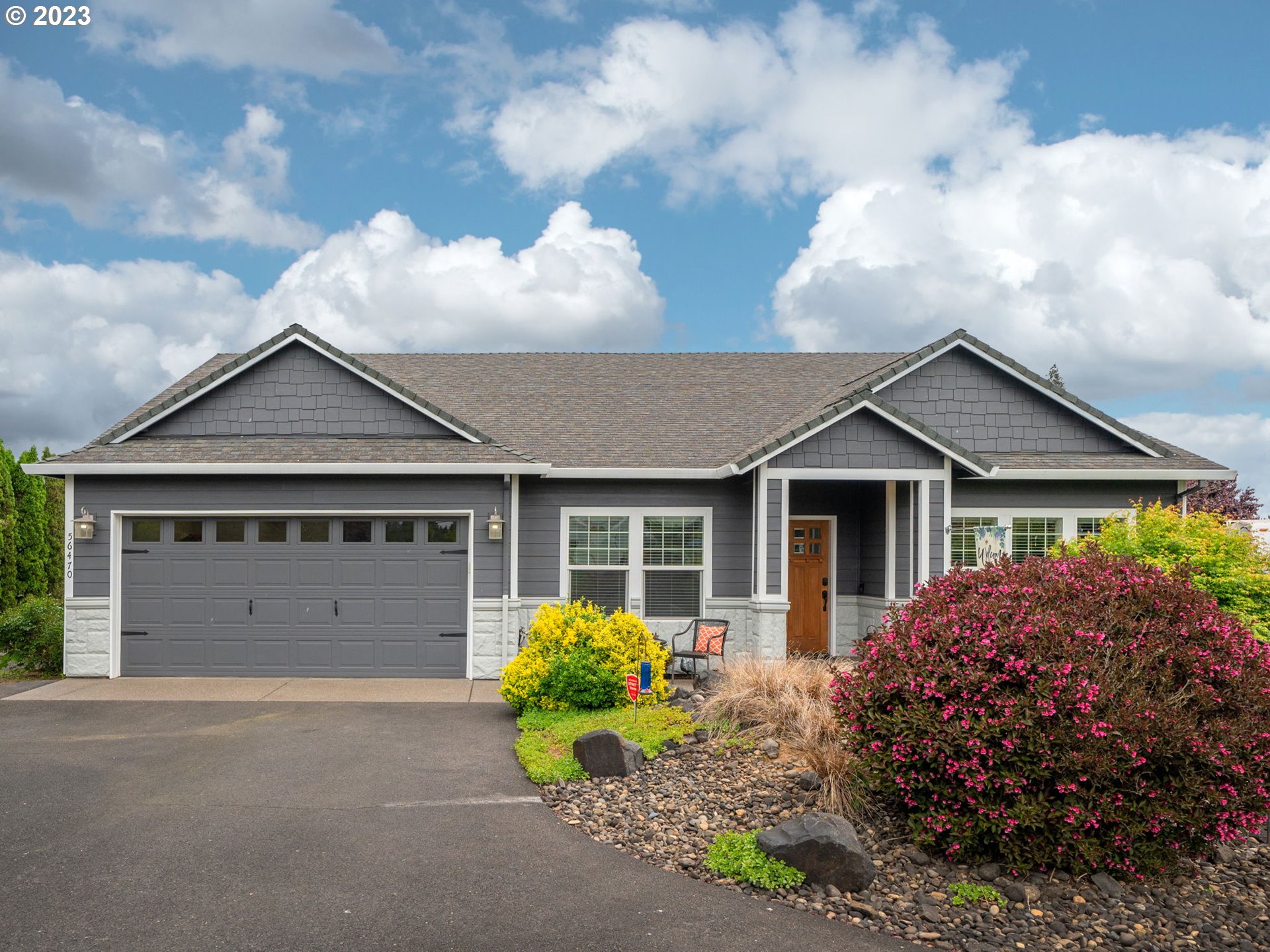 56470 Hazen Road Warren, OR 97053 - Photo 2 of 39 a view of a house with a yard and plants