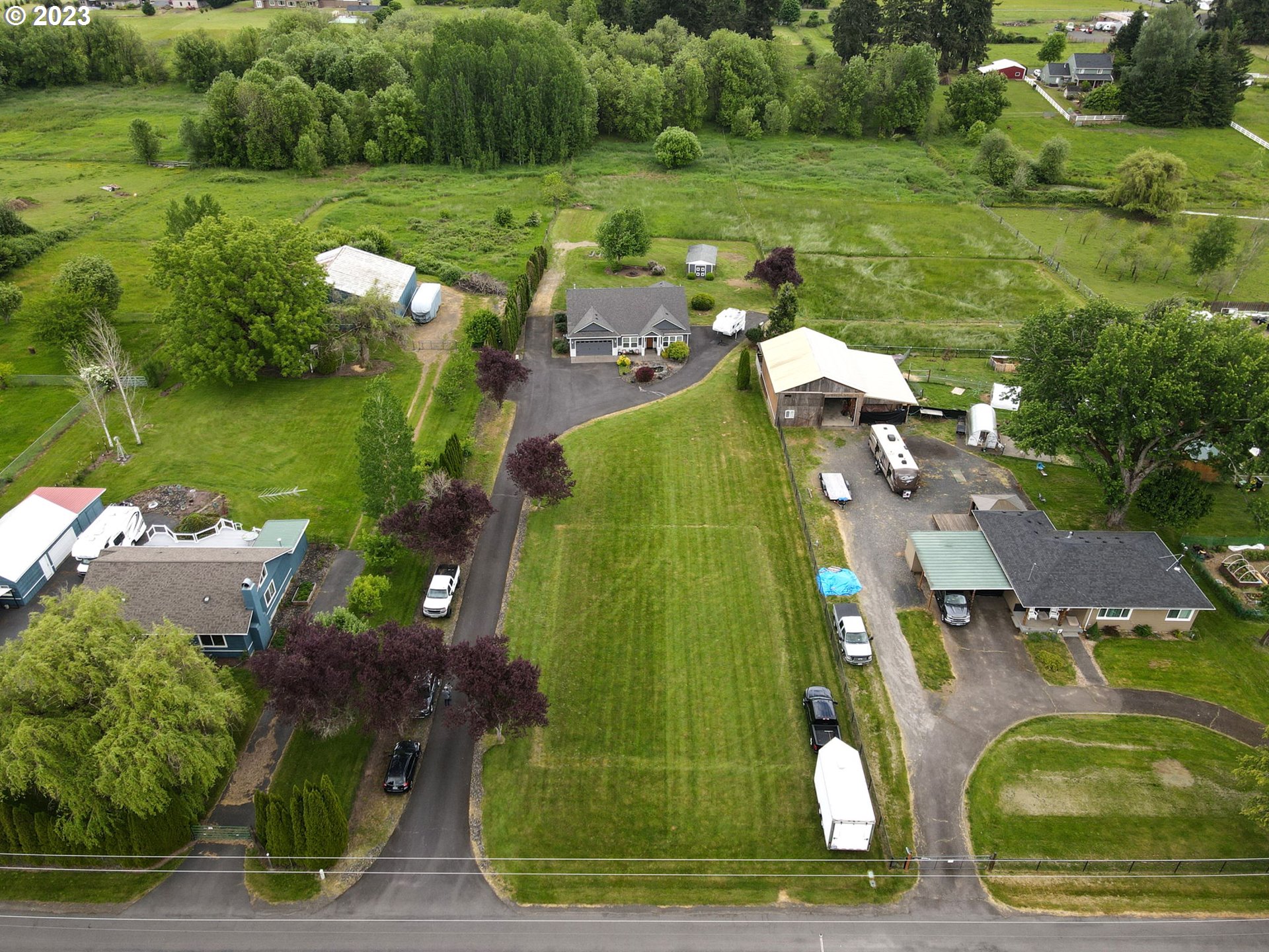 56470 Hazen Road Warren, OR 97053 - Photo 35 of 39 an aerial view of a residential houses with outdoor space and street view