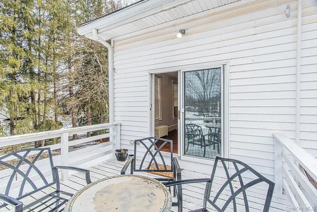 a view of a chairs and table in the balcony