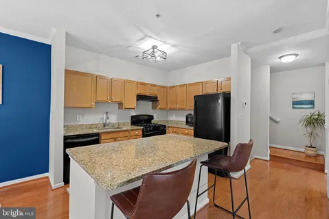 a kitchen with stainless steel appliances granite countertop a stove refrigerator and microwave