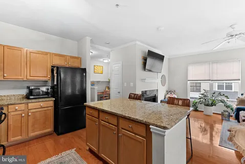 a kitchen with stainless steel appliances granite countertop a refrigerator a stove a sink and a refrigerator